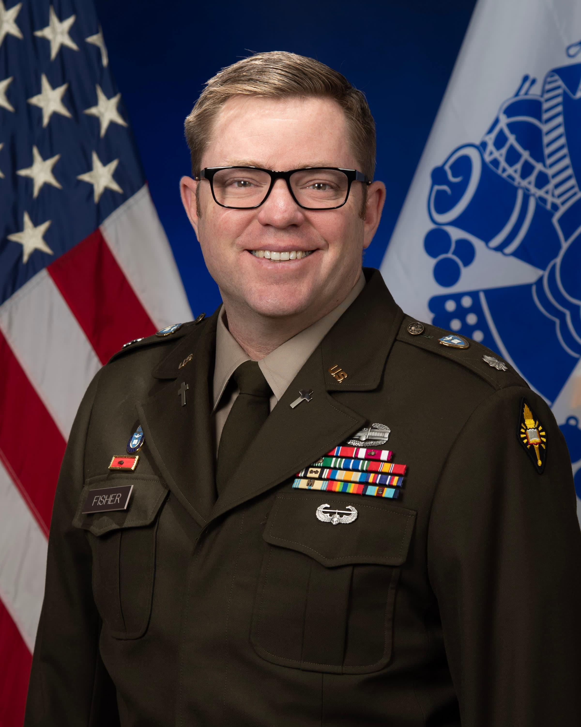 A man in a military uniform standing in front of flags