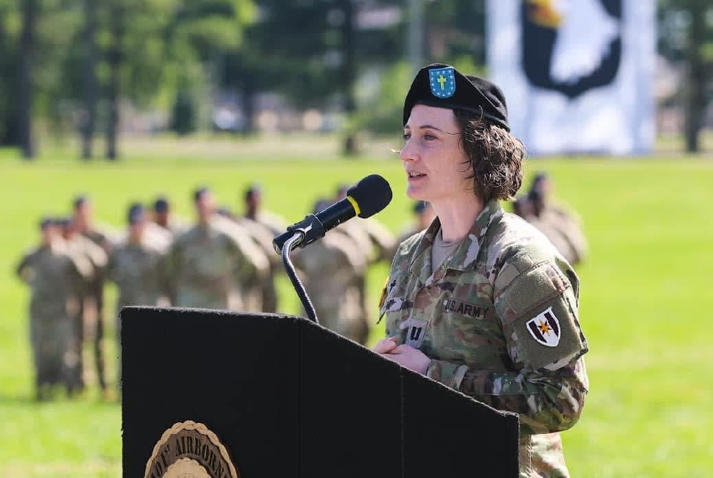 A woman in a military uniform speaking at a podium