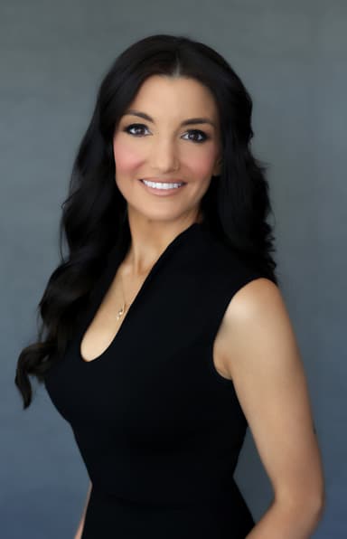 A woman in a black dress posing for a picture