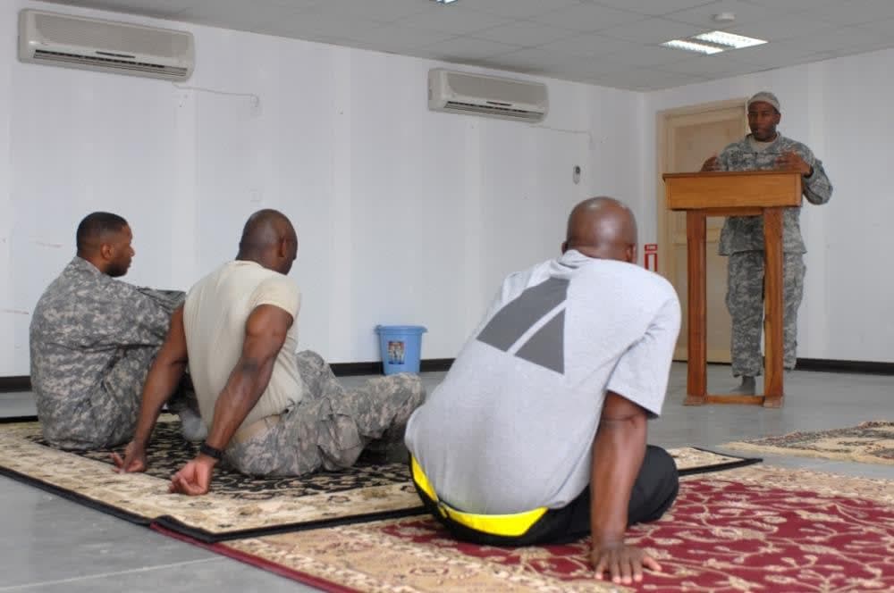 A group of men sitting on top of a rug