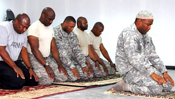 A group of men sitting on top of a rug