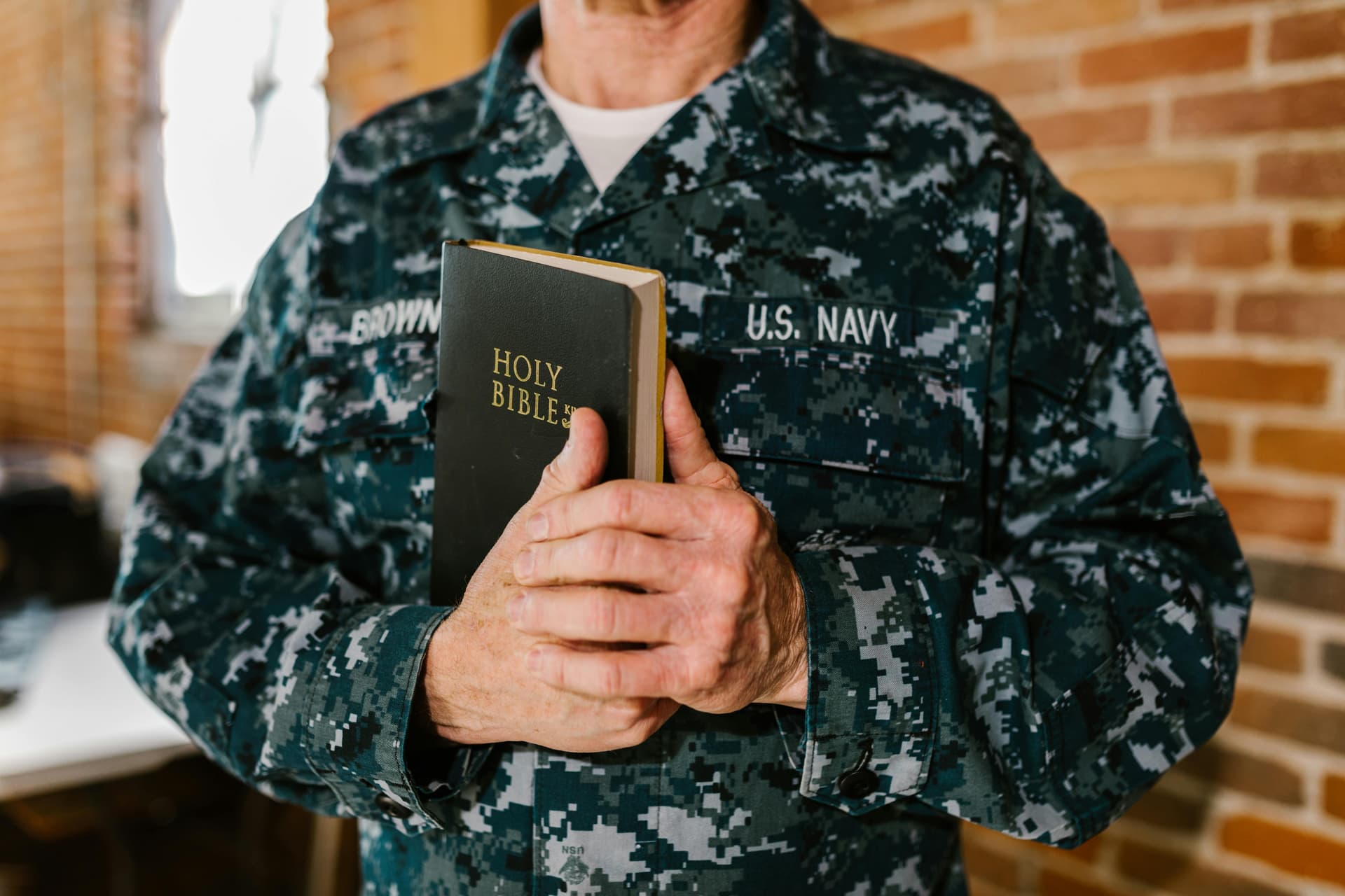 A man in a military uniform holding a book