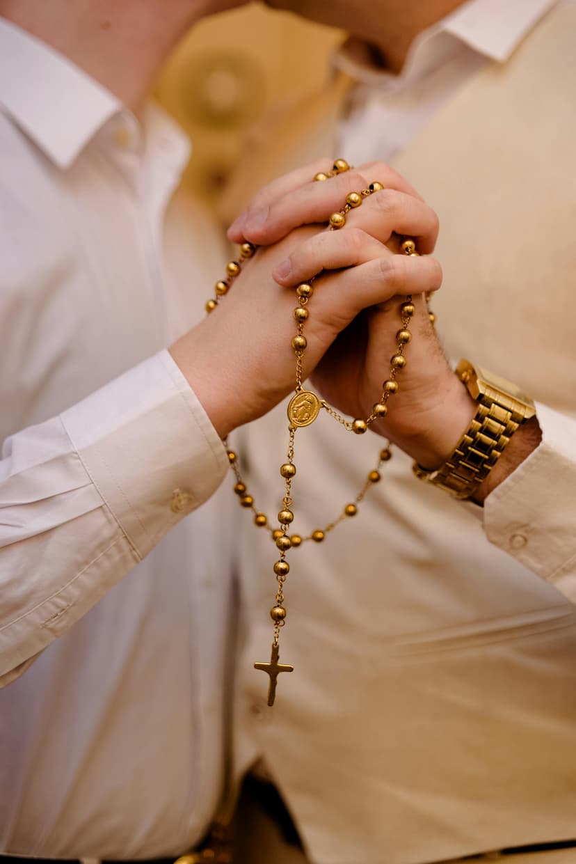 A man and a woman holding a rosary together